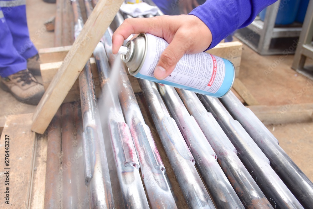 Penetrant Developer Example Penetrant Test , worker apply developer to the welding of workpiece for ...
