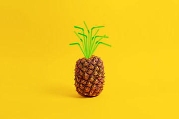 Wall Mural - Pineapple on a yellow background with a straw. Creative concept summer drinks and juice