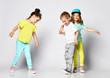 © FAB.1 - Three Small Children - two girls and a boy play have fun in the studio, spinning, brothers and sets, friendship, childhood