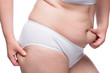 © kosmos111 - obesity concept - overweight on the buttocks and abdomen, stomach close up isolated