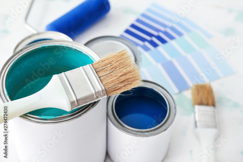 Fotomural Cans of paint with brush on table, closeup