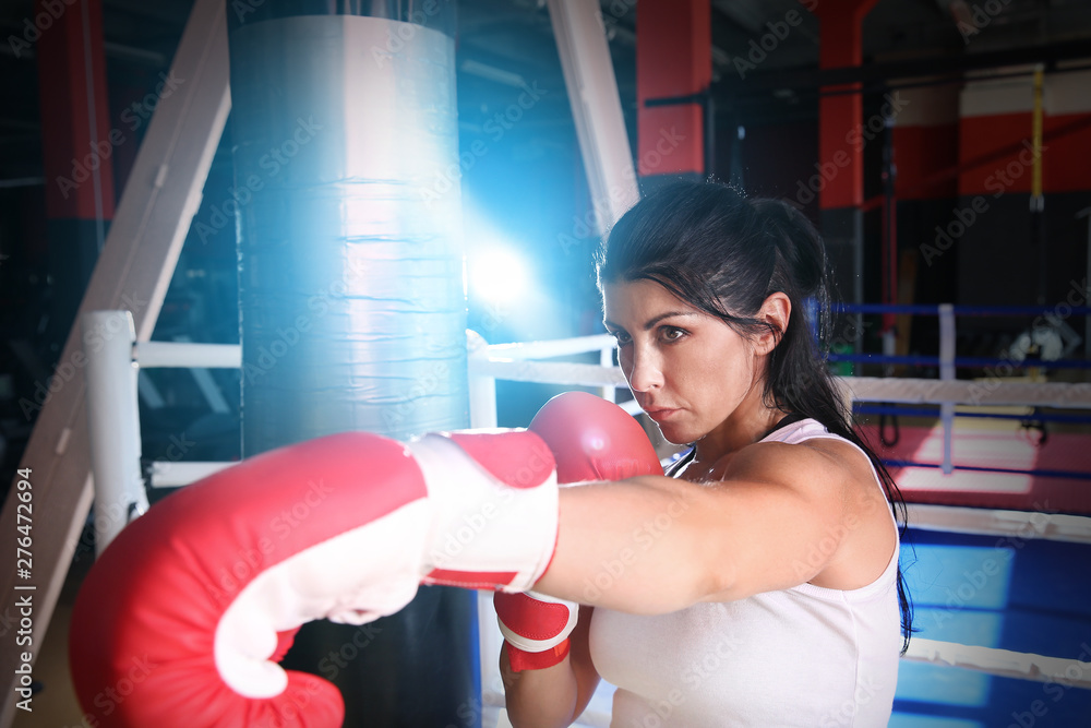 Female boxer training in gym