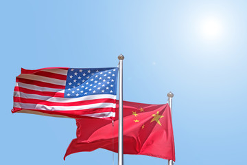 usa and china national flag waving against blue sky side view of natural color of united states of america us and people republic of china state symbols isolated for design mockup copy space template