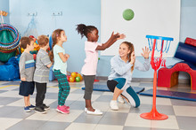 Group Of Kids Exercise Basketball Toss