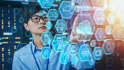 Leinwandbilder - Shot of a Asian IT Engineer Working in a Data Center Server Room and Touching Cloud Icon. Cloud User Interface Concept with Different Computer Illustrative Icons and Symbols in the Foreground.