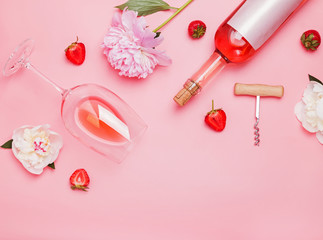 Wall Mural - Creative composition with rose wine and delicious strawberries on the pink background