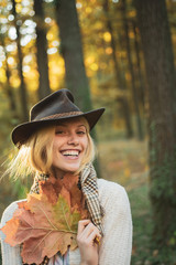 Wall Mural - Sweet young sensual sexy woman walking in autumn park. Autumnal vogue trend. Autumn woman having fun at the park and smiling.