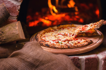 Wall Mural - tasty pizza out of oven in restaurant kitchen