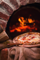 tasty pizza out of oven in restaurant kitchen