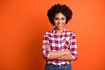 Wall Mural - Portrait of her she nice attractive lovable lovely cheerful cheery content wavy-haired lady wearing checked shirt folded arms isolated on bright vivid shine orange background