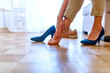© Dragana Gordic - Barefoot woman in office at work. Business woman touching feet with her hand. High heels shoe feet pain. Closeup of woman barefoot with painful toes has removed her formal stilettos