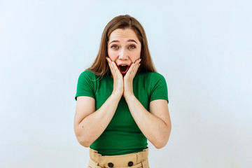 Wall Mural - Surprised,shock ,unbelievable emotion. Young girl face portrait agaist white backgraund.