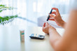 © Dragana Gordic - Close up of mature woman hands using lancet on finger to check blood sugar level by Glucose meter, Healthcare Medical and Check up, Medicine, diabetes, glycemia, health care and people concept