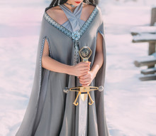 Bravery And Power Of Dark Elves In Cold Winter Forests. Young Woman With Delicate Skin In Long Body With Gray Coat In Snowy Area With Silver Metal Royal Sword In Hands, Creative Photo Without Face