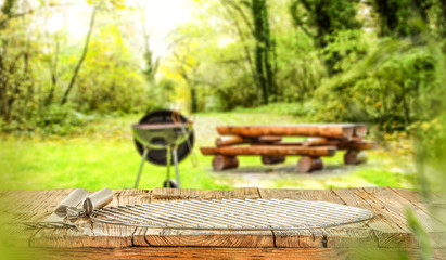 Wall Mural - Wooden old table and grill party in garden. 