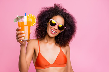 Close up photo beautiful she her dark skin excited model lady raise non sweet diet beverage straw toothy beaming smile cafe bar say toast wear sun specs swimming orange suit isolated pink background