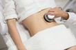Slim woman getting anticellulite and anti fat therapy in beauty salon