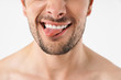Cropped photo closeup of funny naked man grimacing at camera with sticking out his tongue