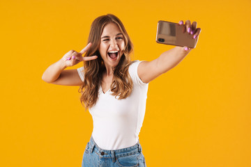 Wall Mural - Portrait of a cheerful young casual girl standing