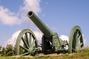 Old metal cannon. Shipka, Gabrovo, Bulgaria. The Shipka Memorial is situated on the peak of Shipka in the Balkan Mountains near Kazanlak, Bulgaria. Old metal cannons against blue sky with clouds.