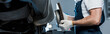 © LIGHTFIELD STUDIOS - panoramic shot of car mechanic holding metallic car brake near automobile