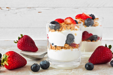 Wall Mural - strawberry and blueberry parfaits in glasses against a bright white background
