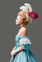 Side View Of Elegant Victorian Woman In Wig And Blue Dress Isolated On Grey