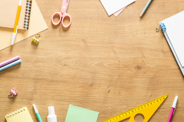 Wall Mural - Flat lay school stationery on a wooden background. Back to school concept, creative layout. Top view, overhead.