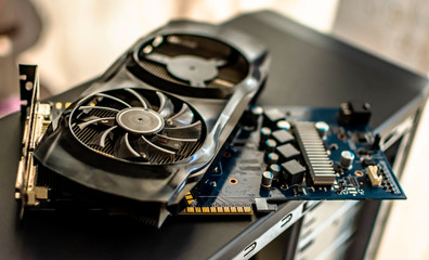 components of a personal desktop computer a disassembled board video card with a cooler lies on the case of a personal computer