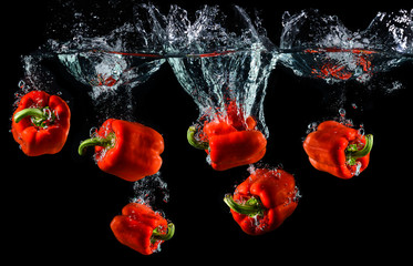 Wall Mural - Water droping red bell pepper or paprika.