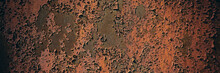 Rusty Metal Sheet Surface Coated With Decaying Paint.