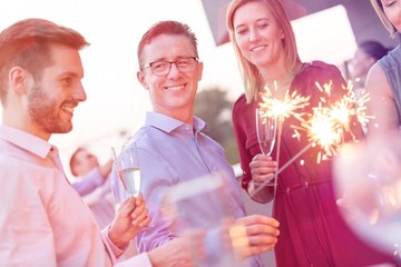 Canvas Print - Business people on a rooftop party.