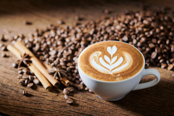 white coffee cup and roasted coffee beans around