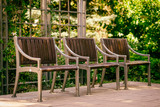 Fototapeta Boho - Three empty wooden benches. Summer sunny day