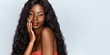© Beauty Agent Studio - Beautiful African woman portrait. Brunette curly haired young model with dark skin touching her chin and posing against grey background .