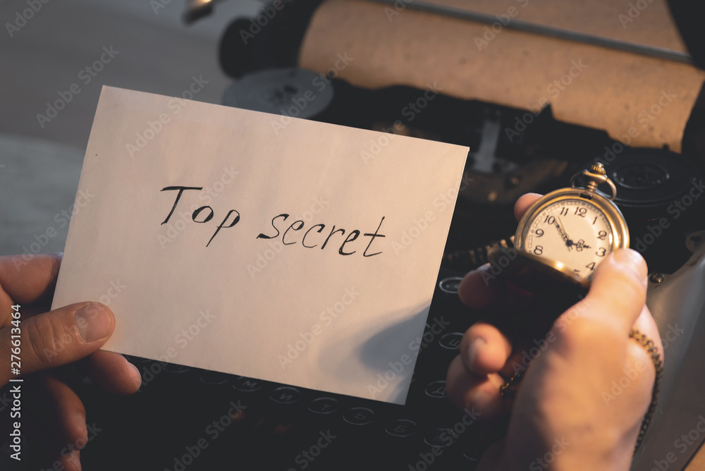 Top secret document letter and a pocket watch in a detective spy agent ...