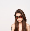 © Dave Studio - sunglasses girl, close up studio shot of beautiful fashion young woman model with long hair looking at camera . while posing against clean white blank copy space wall for your content