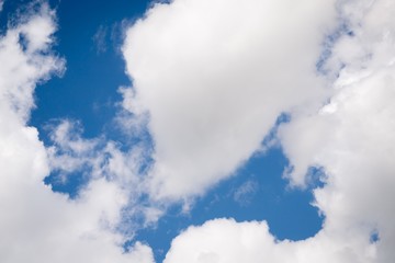 Wall Mural - Beautiful sky background. White fluffy clouds on a deep blue sky background. Scenic sky