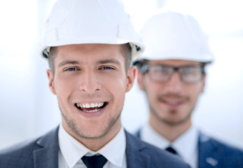 Wall Mural - businessmen in hard hats close-up