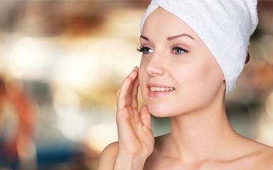 Poster - Portrait of beautiful young woman  in white towel on head on background