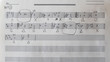 Handwritten musical notes, music theory exercise on paper