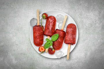 Wall Mural - Strawberry popsicles with fruits, frozen homemade ice pops