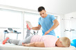 © Pixel-Shot - Physiotherapist working with mature patient in rehabilitation center