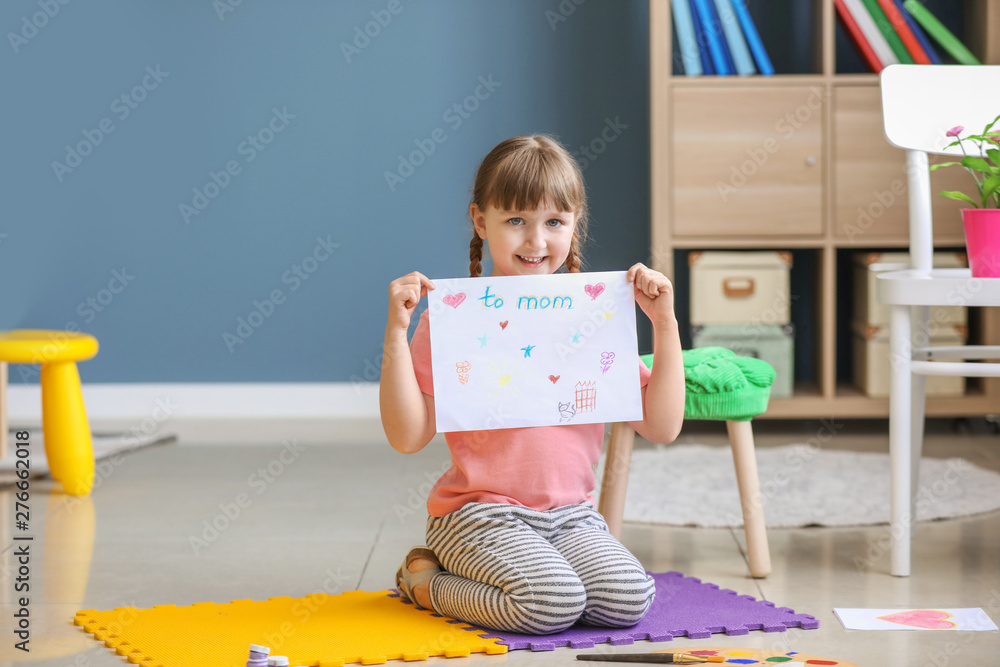 Cute little girl drawing at home