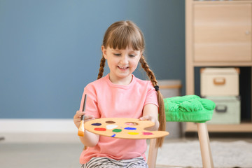 Wall Mural - Cute little girl painting at home