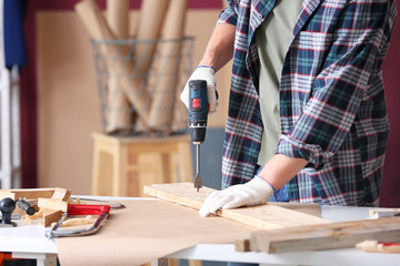 Wall Mural - Male carpenter working in shop