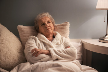 Canvas Print - Senior woman suffering from insomnia at night