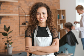 Poster - Young African-American hairdresser in beauty salon