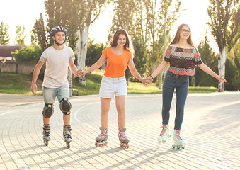 Wall Mural - Teenagers on roller skates outdoors