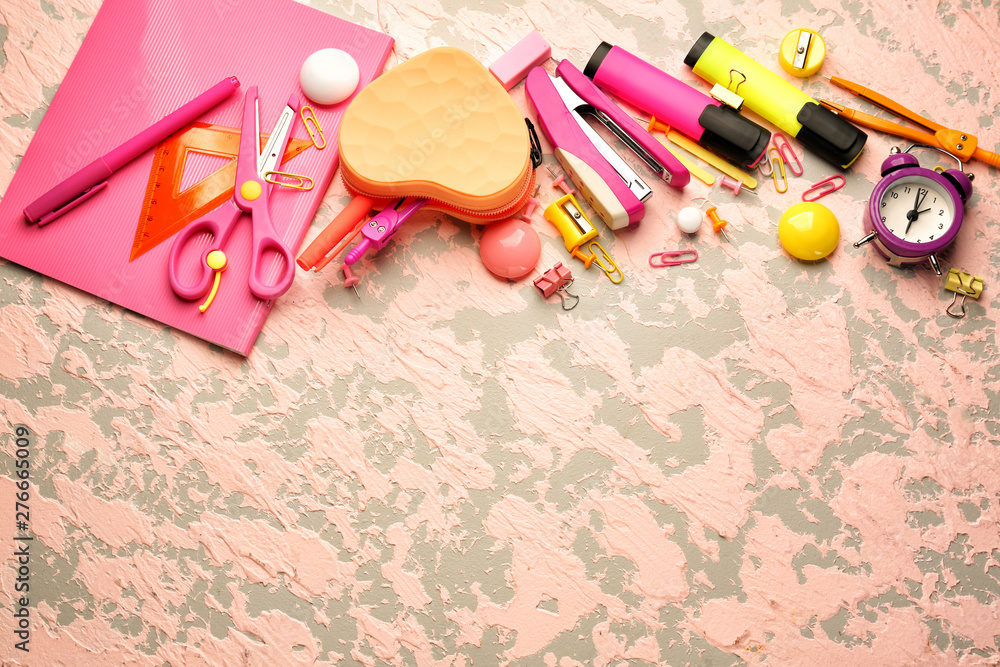 Different school stationery on color background